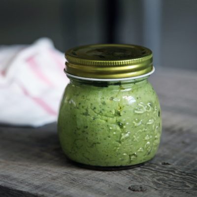 A jar full of green pesto
