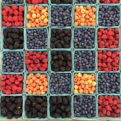 Hallocks of fresh berries, including raspberries, blackberries and blueberries.