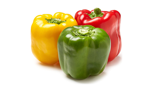 Group of fresh green peppers, including one green, one yellow, and one red, on a white backdrop.